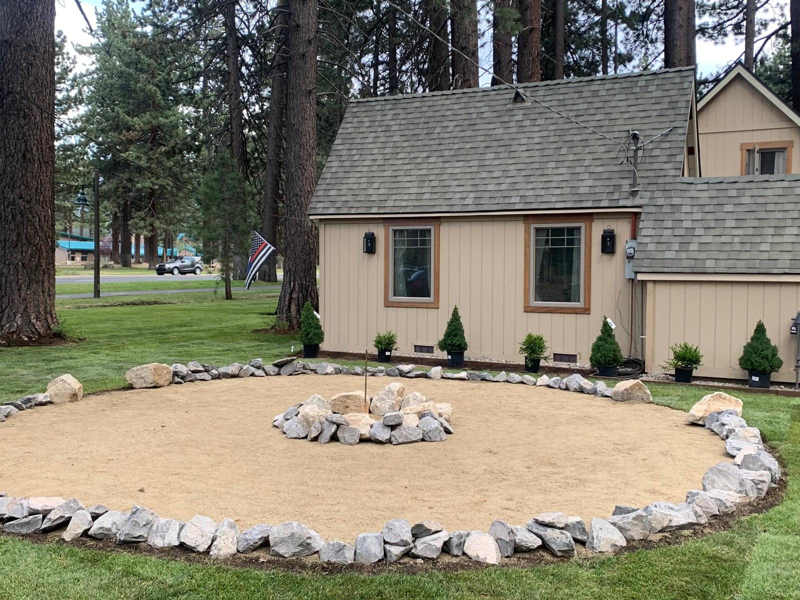 Custom stone-edged fire pit and gravel patio installed at a South Lake Tahoe home