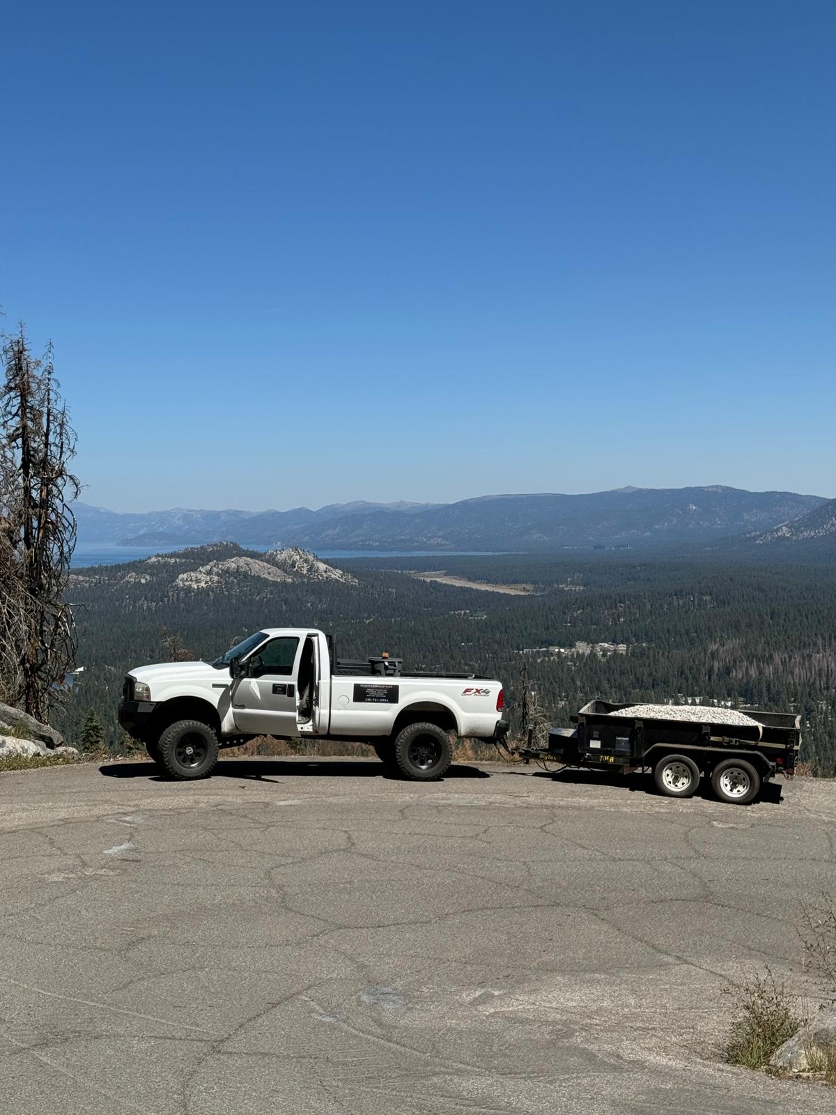 Stamparini Services truck and dump trailer at a Tahoe basin overlook